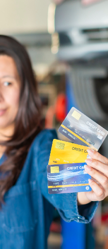 Woman holding out three different credit cards